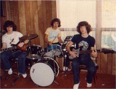 Playing my first set of drums with my brothers on guitar