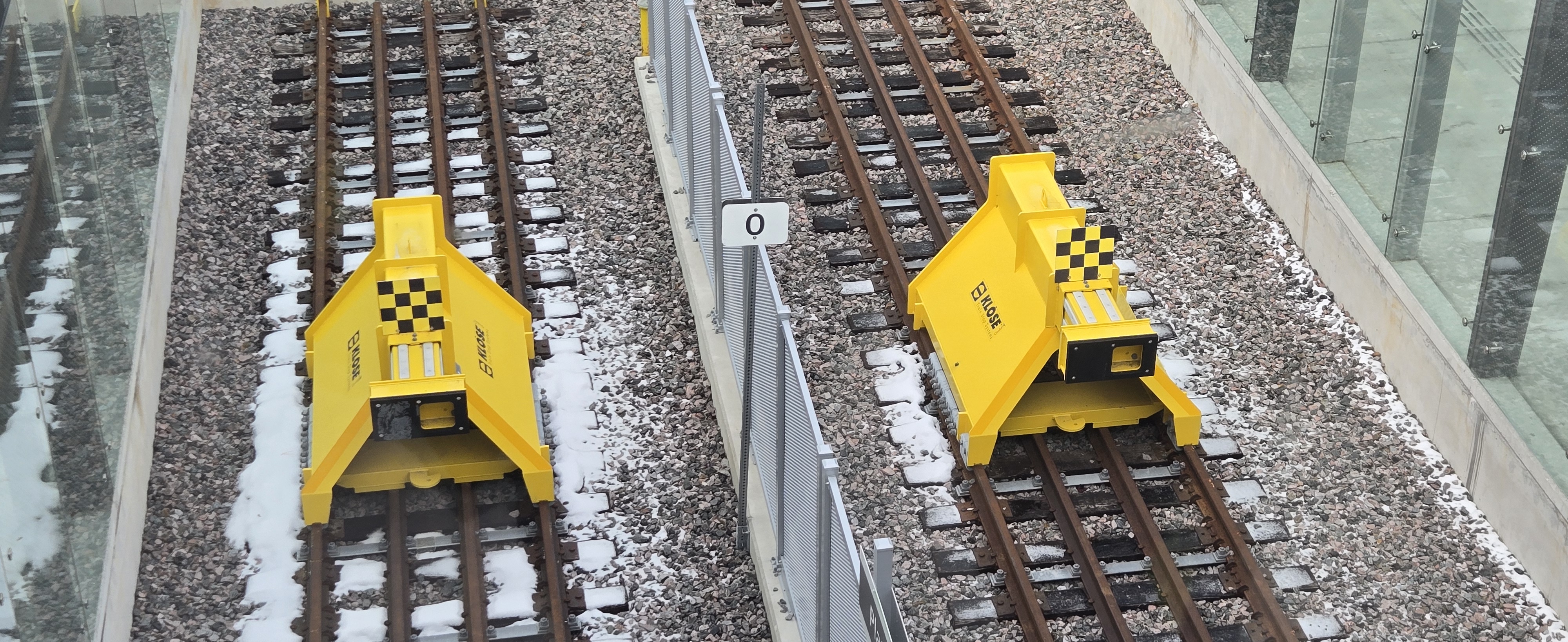 Two yellow train stoppers on tracks